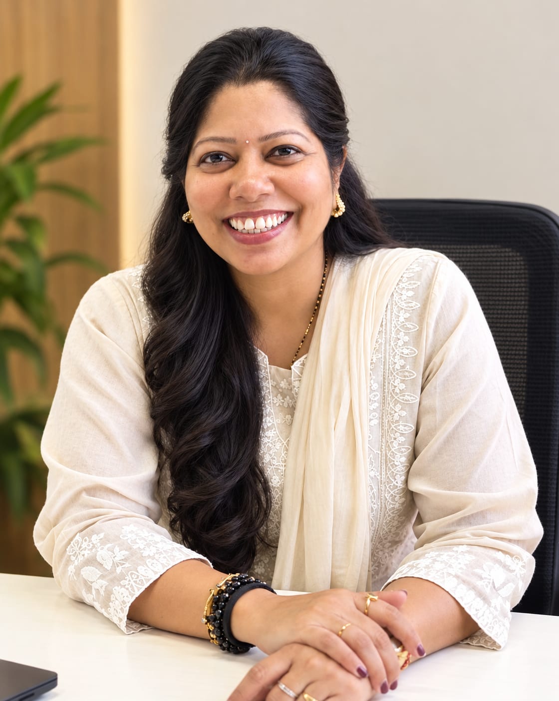 Prachi Prabhu seated at her desk in the Zeal & Heal office