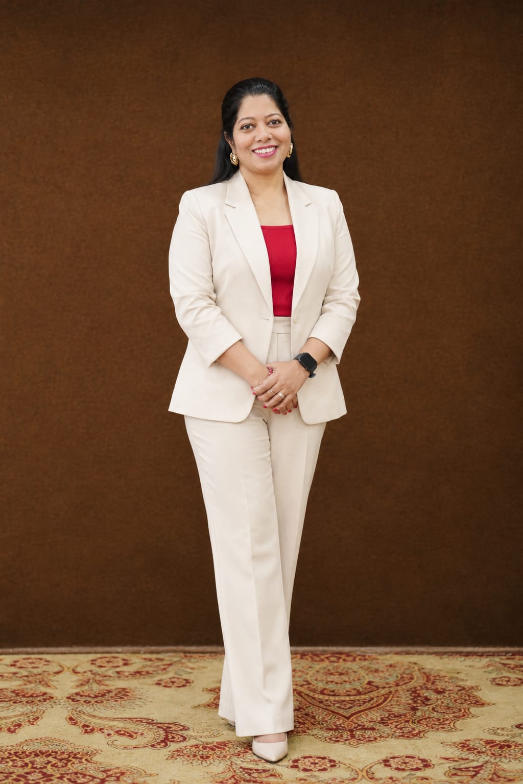 Prachi Prabhu, founder of Zeal & Heal, smiling in a cream suit